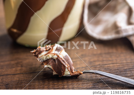 Chocolate cream spread in spoon on wooden table. Chocolate cream spread in spoon on wooden table. 119816735