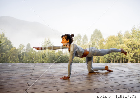 Morning Yoga in Nature's Embrace 119817375