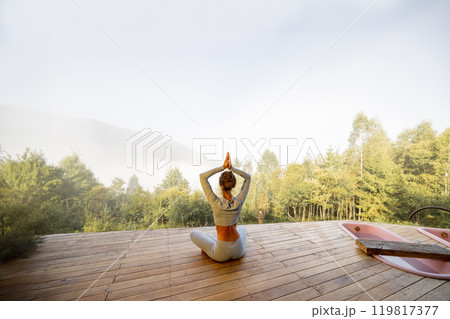 Morning Yoga in Nature's Embrace 119817377