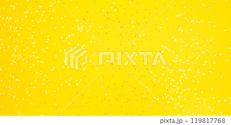 Tiny pearl stars on yellow background. Flat lay, top view. 119817768