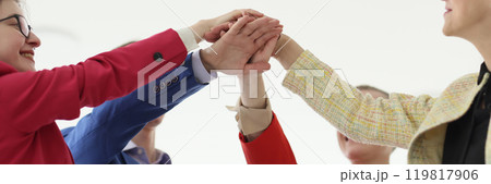 Happy businesspeople join hands during teambuilding training 119817906