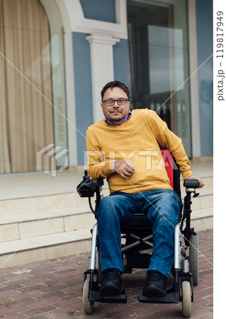 Man with Disabilities in Wheelchair Walking 119817949