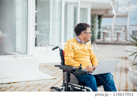 Man In Wheelchair Working Online Learning On Laptop 119817952