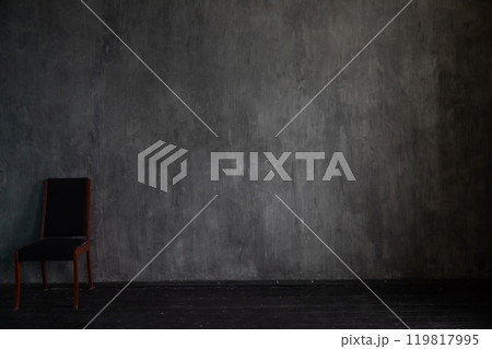 One vintage black chair in the interior of an empty gray room One vintage black chair in the interior of an empty gray room 119817995