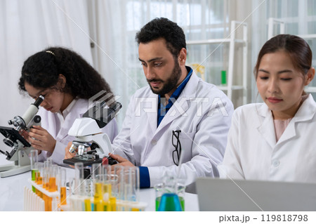 Scientist team in white laboratory coat working with microscope and laptop for research in scientific research laboratory . 119818798