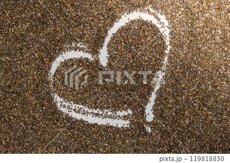 Heart made of chia seeds background. Healthy superfood rich in Omega 3 fatty acids. Dry healthy natural ingredient. Vegetarian food favorite dietary Heart made of chia seeds background. Healthy superfood rich in Omega 3 fatty acids. Dry healthy natural ingredient. Vegetarian food favorite dietary 119818830