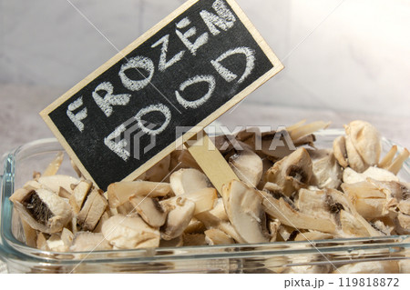 Frozen food sliced mushrooms champignon with blackboard wooden label and text FROZEN FOOD homemade. Harvesting concept. Stocking up vegetables for winter storage Healthy food Frozen food sliced mushrooms champignon with blackboard wooden label and text FROZEN FOOD homemade. Harvesting concept. Stocking up vegetables for winter storage Healthy food 119818872
