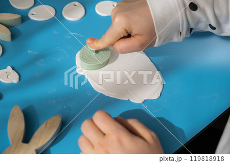 Workshop cutting figures Unrecognizable artist do it yourself air dry clay crafts for Easter holiday. Decoration gift idea Handmade children craft. Step by step instruction of painting, pressing 119818918