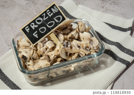 Frozen food sliced mushrooms champignon with blackboard wooden label and text FROZEN FOOD homemade. Harvesting concept. Stocking up vegetables for winter storage Healthy food 119818930