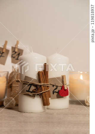 Candle with advent calendar Traditional Burning Christmas Wax Candles with numbers counting down for Christmas. Beautiful Advent At Home. Festive Candlelight And Dark Background 119818937