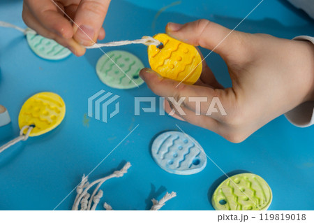 Unrecognizable artist do it yourself air dry clay crafts for Easter holiday. Decoration gift idea Handmade children craft. Step by step instruction of painting, pressing figures 119819018