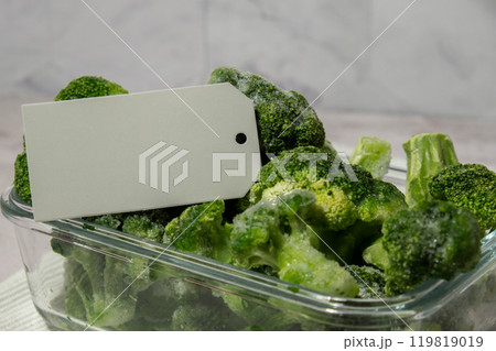 Frozen food broccoli florets with empty paper note copy space for text homemade. Harvesting concept. Stocking up vegetables for winter storage. Healthy food Frozen food broccoli florets with empty paper note copy space for text homemade. Harvesting concept. Stocking up vegetables for winter storage. Healthy food 119819019