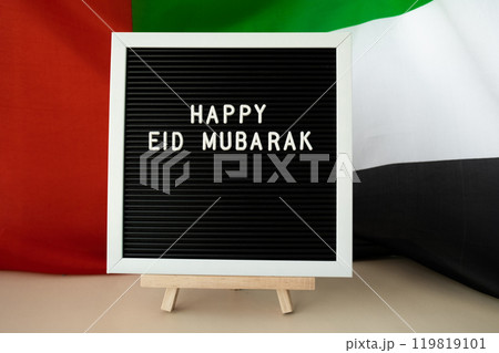 Message text HAPPY EID MUBARAK - happy holidays waving UAE flag on background concept. Greeting card advertisement. Commemoration Day Muslim Ramadan Blessed holy month public holiday Message text HAPPY EID MUBARAK - happy holidays waving UAE flag on background concept. Greeting card advertisement. Commemoration Day Muslim Ramadan Blessed holy month public holiday 119819101