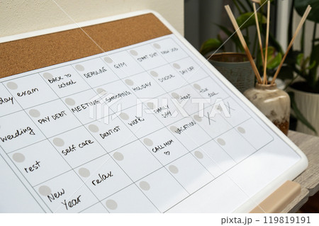 Monthly PLANNER filled with appointments and plans for next month. Busy month schedule Magnetic board with the days of the month. Place to enter important matters schedule. Concept for business Monthly PLANNER filled with appointments and plans for next month. Busy month schedule Magnetic board with the days of the month. Place to enter important matters schedule. Concept for business 119819191