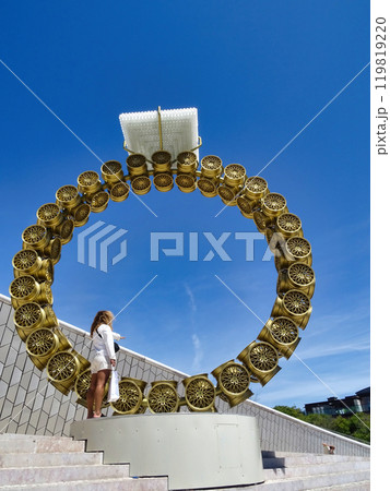 Lisbon, Portugal - July 22, 2024 A view of an immense sculpture by Joan Vasconcelos called Solitaire on the bank of the Tagus river, at the MAAT, Museum of Art, Architecture and Technology. 119819220