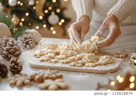 Woman making Christmas cookies at table in kitchen, closeup of hands 119819874
