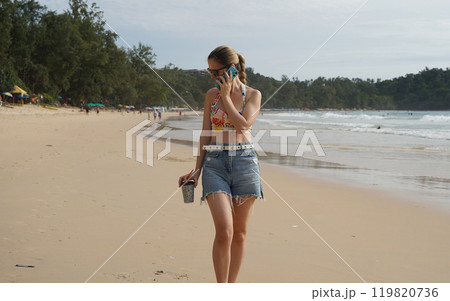 A young woman enjoying a beautiful day at the beach  119820736