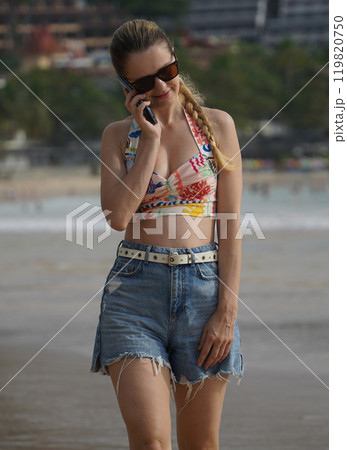A young woman enjoying a beautiful day at the beach  119820750