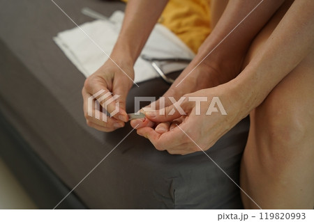 A woman doing a manicure and pedicure 119820993