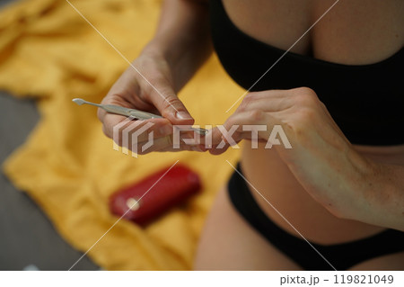 A woman doing a manicure and pedicure A woman doing a manicure and pedicure 119821049