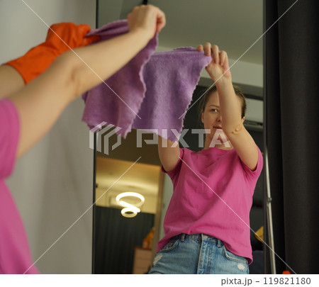 A woman is cleaning her living room at home A woman is cleaning her living room at home 119821180