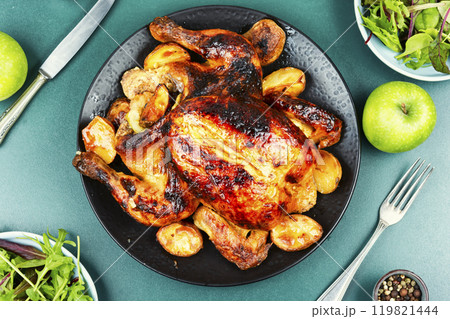 Roasted, baked chicken with potatoes and apples. Roasted, baked chicken with potatoes and apples. 119821444