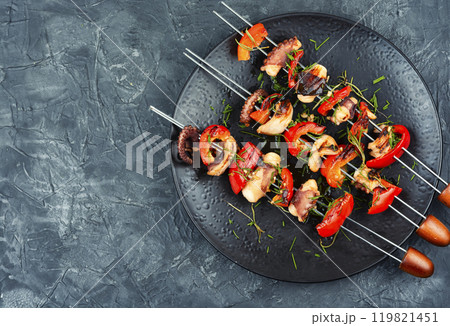Grilled octopus on skewers. Grilled octopus on skewers. 119821451