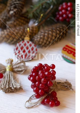 DIY decorations for Christmas. Xmas ornaments. Christmas composition with Ukrainian doll-motanka, wood balls, snowball tree, cones and fir branches. New Year eco-conscious handmade toys. Happy holiday 119821714