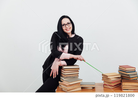 business woman teacher, a librarian and many stacks of books to read 119821800