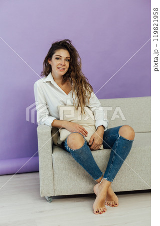 Beautiful woman in home clothes on the sofa Beautiful woman in home clothes on the sofa 119821958
