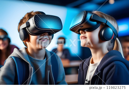 Interactive school concept. Kids in VR headsets sitting at desks and having virtual reality learning experience. Study technology. Kids in VR glasses in classroom. Tech education. 119823275