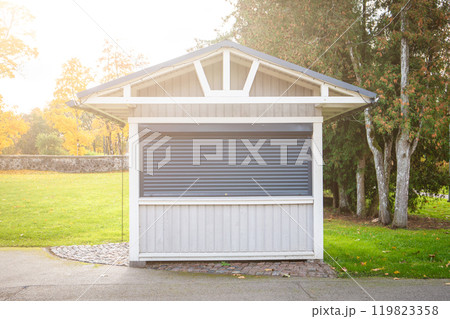 Locked tourist souvenir kiosk. Sunny autumn day Locked tourist souvenir kiosk. Sunny autumn day 119823358