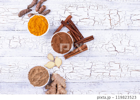 Powder of turmeric, cinnamon and ginger 119823523