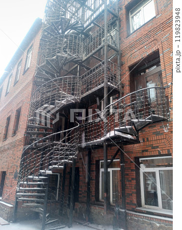 Black metal spiral staircase with metal fencing on the landings and steps. 119823948