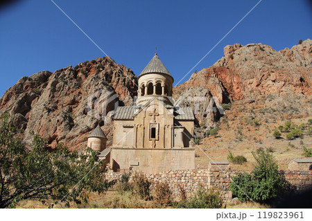 Ancient orthodox church building with a bell tower on a rocky mountainside 119823961