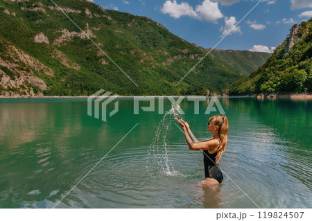 Woman in Swimwear Splashing Water in Mountain Lake Woman in Swimwear Splashing Water in Mountain Lake 119824507