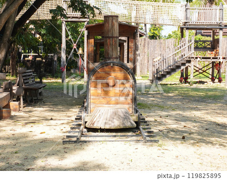 Summer park playground with swings, slides and climbing equipment. Modern wooden playground equipment for children's amusement park. 119825895