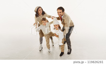 Joyful happy family spending good time with kids, boy and girl. All four dressed in warm stylish winter clothes. Laughter and joy. 119826281