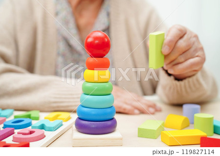 Asian elderly woman playing game. Asian elderly woman playing game. 119827114