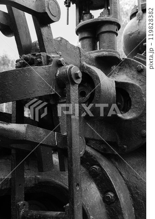 Massive parts of vintage black industrial machine, close up 119828382