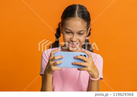 Happy girl playing racing drive simulator shooter video games on smartphone celebrate victory win 119829368