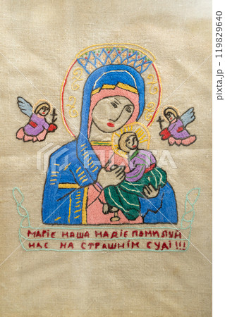 Ukrainian old embroidery. The Virgin Mary is embroidered on the fabric with threads. 119829640