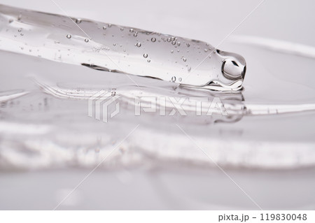Dropper pipette with delicious serum with bubbles on the gel texture. 119830048