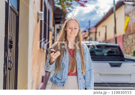 Female tourist walks through the colonial streets San Cristobal de las Casas, Mexico. Cultural exploration, architecture, and travel experience concept 119830553