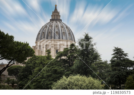 St. Peter's Basilica rising out from canopy of trees in the Vatican 119830573