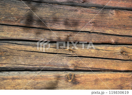 a close-up of a weathered wooden surface, with long horizontal wooden planks 119830619