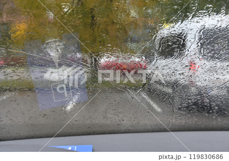a rainy day scene as viewed through a car windshield 119830686