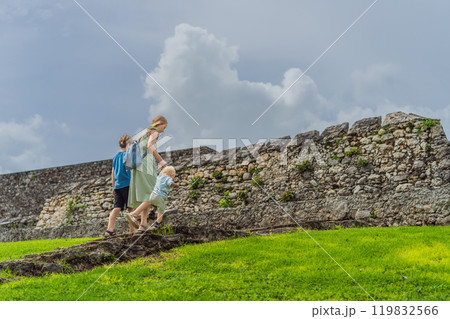 Mother with her toddler and teenage sons exploring Fuerte de San Felipe de Bacalar. Family travel, cultural heritage, and historical adventure concept 119832566