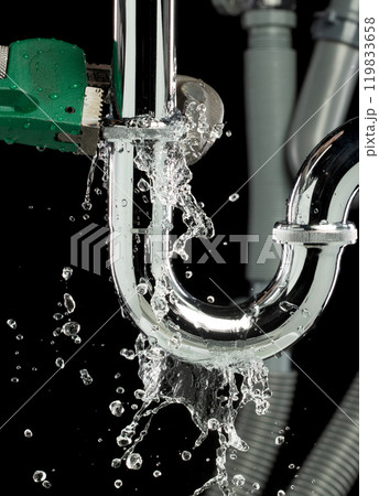 Heavy Duty Wrench fix Water leak under sink. Drain sink leak water from many pipe hose plumbing in bathroom and repair by wrench tools as water splash drop. Black background isolated Heavy Duty Wrench fix Water leak under sink. Drain sink leak water from many pipe hose plumbing in bathroom and repair by wrench tools as water splash drop. Black background isolated 119833658