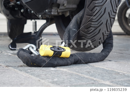 This is a secure motorcycle lock that features a heavyduty chain combined with a padlock 119835239